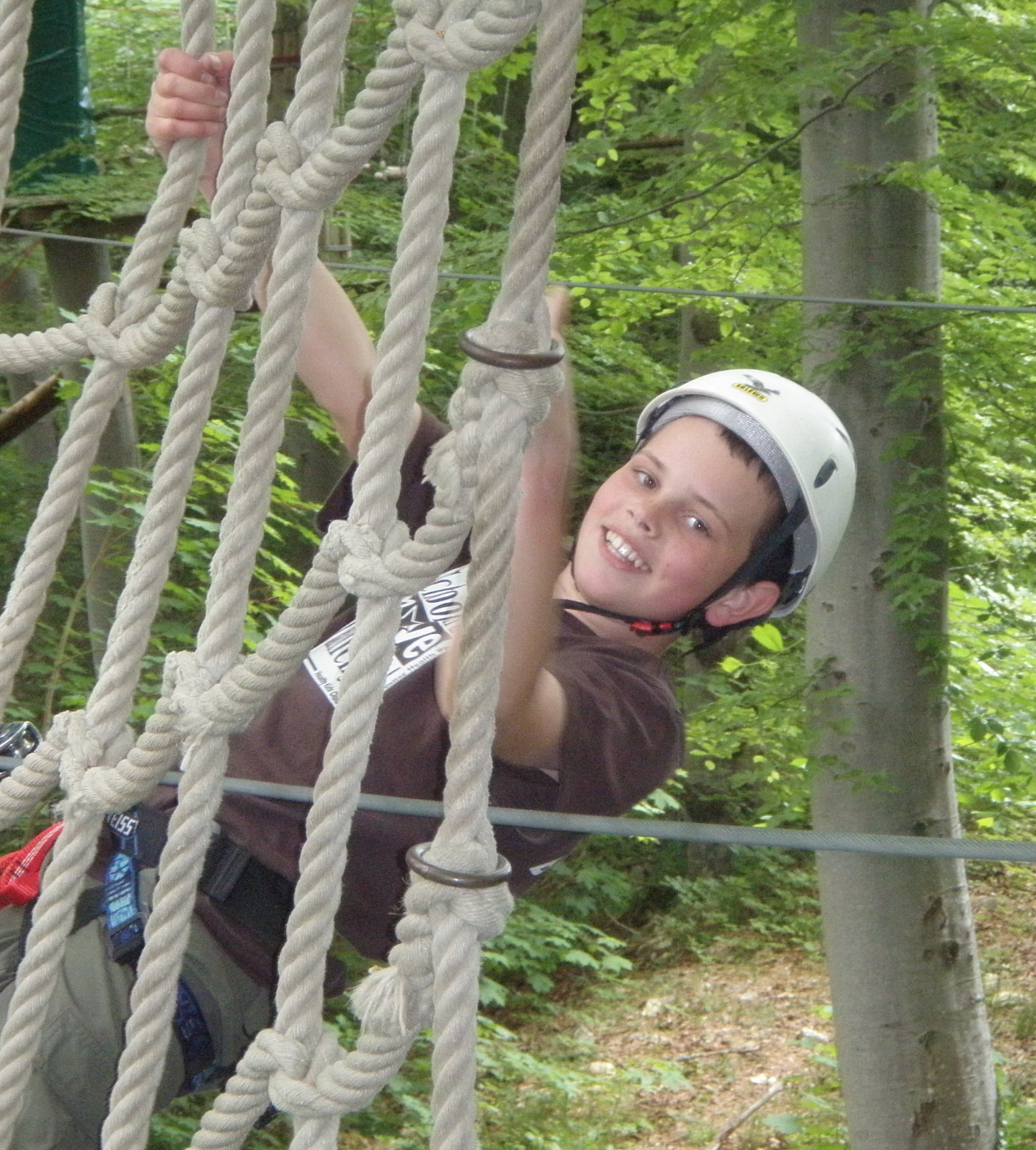 Nicolas climbs in a forest park with his BSA Troop