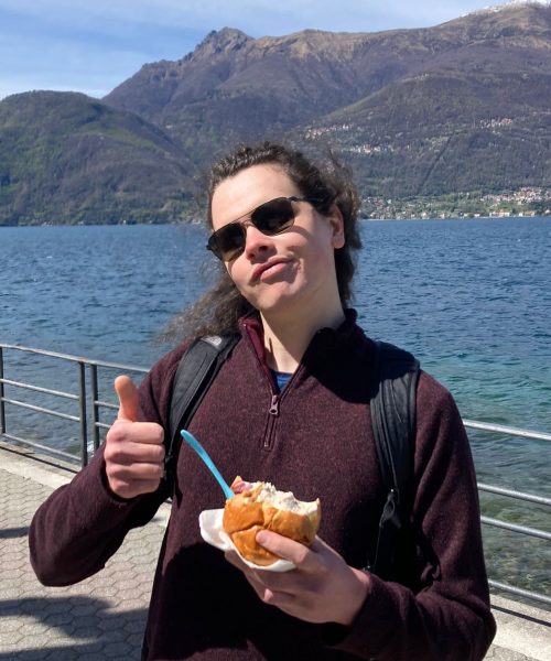 Nick gives a thumbs up while eating a brioche with gelato inside